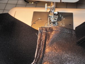 Stitch with zipper foot or hand stitch along underwire